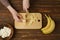 Unrecognizable person cutting banana slices