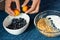 Unrecognizable person makes breakfast with blueberry and fruit