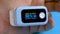 Unrecognizable person monitoring oxygen saturation by pulse oximeter
