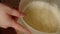 Unrecognizable person stirring dough in bowl with whisk. Unknown housewife preparing dough. Close up. Concept of making