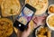 Unrecognizable person using smartphone taking photo top view shot various kinds of delicious tasty juicy cheesy pizza placed on