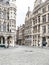 Unrecognizable person walking alone on the Grand-place of Brussels with a protective mask during the crisis COVID-19