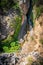 Unrecognizable persons canyoning with ropes under the stream