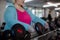 Unrecognizable plus size woman training taking dumbbells indoors in gym