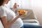 Unrecognizable Pregnant Lady Eating Fresh Vegetarian Salad From Bowl, Enjoying Healthy Nutrition