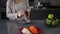 An unrecognizable pregnant woman peels vegetables for a salad. A woman peels red beetroot with a vegetable peeler while