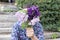 Unrecognizable romantic man covering face with purple bouquet