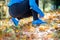 Unrecognizable runner sitting on the ground, tying shoelaces, au