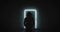 Unrecognizable silhouette of a person with a hood stands in front of a glowing frame of a door in the dark corridor. Zoom in.