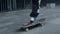 Unrecognizable skater balancing on board outdoor. Man feet running outside.