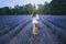 Unrecognizable slim woman running in lavender field.