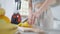 Unrecognizable slim young woman cutting lemon with kitchen knife at home. Slender fit lady preparing ingredients for