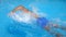 Unrecognizable sporty guy floating across pool with clear blue water. Young man swimming and enjoying recreation on