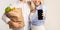 Unrecognizable Spouses Showing Mobile Phone Screen Holding Bag, Studio Background