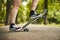 Unrecognizable teenager girl starting skateboarding on asphalt road in a park - Wanderlust and skateboarder outdoor lifestyle