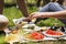 Unrecognizable teenagers camping and cooking.