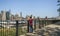 Unrecognizable tourist man taking photos with smartphone of Manhattan skyline