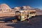 Unrecognizable tourist visits abandoned bus in the desert of Atacama, Chile