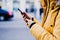 unrecognizable tourist woman using mobile phone outdoors in the street. lifestyle and travel concept