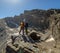 Unrecognizable tourists standing on rock