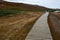 Unrecognizable tourists walking on a path in Leirhnjukur clay hill in Iceland,overcast day in summer , film effect