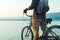 Unrecognizable Traveler Man Standing With Bike On Coast And Enjoying View of Nature Sunset Vacation Traveling Relaxation Resting C