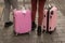 Unrecognizable two young girls, travelers standing near a suitcases, street city, travel and tourism concept