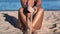 Unrecognizable woman beauty body bikini pouring sand through hand finger sea beach summer vacation