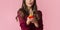 Unrecognizable woman blowing colourful candles on birthday cupcake