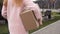 Unrecognizable woman carries cardboard box outdoor