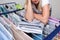 Unrecognizable woman collecting dry clean clothes, linen and towels from a drying rack and putting it in stack, washing and drying