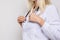 Unrecognizable woman doctor physiotherapist in white uniform with stethoscope on white background