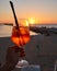 Unrecognizable woman holding a glass of Spritz traditional cocktail with alcohol at a beach bar. European summer drink. Italian
