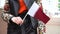 Unrecognizable woman holding Qatari flag. Girl walking down street with national flag of Qatar