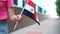 Unrecognizable woman holding Syrian flag. Girl walking down street with national flag of Syria