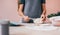 Unrecognizable woman painting ceramic bowl