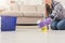 Unrecognizable woman polishing wooden floor