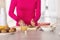 Unrecognizable woman putting in a bowl the pieces of kiwi she has just cut up