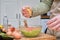 Unrecognizable woman smashing a lemon over the guacamole