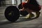 Unrecognizable woman standing behind a barbell.