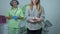 Unrecognizable worried teenage girl standing in hospital with blurred gynecologist waiting at gynecological chair at