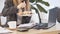 Unrecognizable young business woman having a lunch break at desk, she is eating fresh salad, person