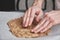 Unrecognizable young caucasian man in apron kneading the dough in a kitchen