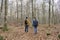 Unrecognizable young couple walking with backpacks in amazing autumnal forest.Hiking , travel wanderlust concept.Romantic and