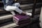 Unrecognizable young girl student sitting resting on the steps with a suitcase, youth travel and tourism concept