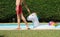 Unrecognizable young man walking a big unicorn inflatable ring at a swimming pool