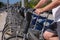 Unrecognizable young sporty man renting a bicycle from bike share stand in a city