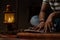 unrecognizable Young student busy reading during night under oil lamp or lantern due to power loss and Poverty - concpet