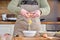 Unrecognizable young woman cracking or breaking an egg on a bowl