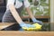 Unrecognizable young woman disinfecting kitchen counter with microfiber